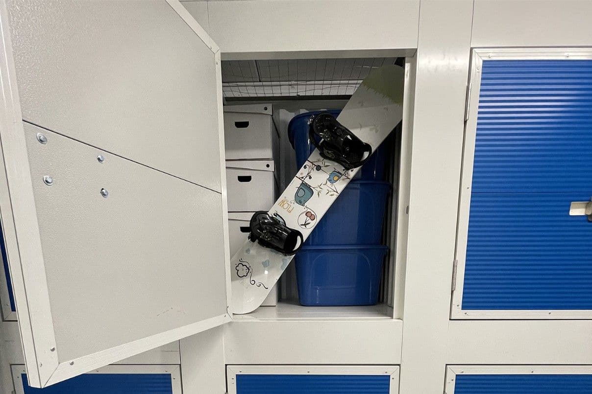 Snowboards and bins stored in a small unit at CityBox Midtown